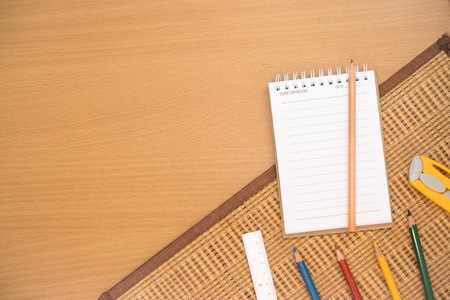 Notepad with pencil on wood board background.using wallpaper for education, business photo.Take note of the product for book with paper and concept or copy space.の写真素材