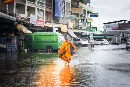 BANGSAN, THAILAND - September , 2017 Monks are walking on the flood street in thailand for receive food.のeditorial素材