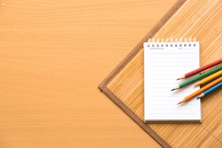  Notepad with pencil on wood board background.using wallpaper for education, business photo.Take note of the product for book with paper and concept or copy space.の写真素材