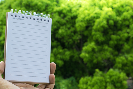 Notepad on tree blurry background.using wallpaper for education, business photo.Take note of the product for book with paper and concept, object or copy space.の写真素材
