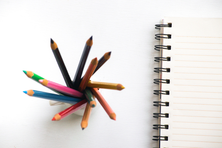 Notepad with pencil on wood board background.using wallpaper for education, business photo.Take note of the product for book with paper and concept, object or copy space.の写真素材