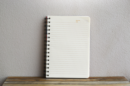 Notepad on wood board background.using wallpaper for education, business photo.Take note of the product for book with paper and concept, object or copy space.の写真素材