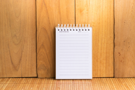 Notepad with pencil on wood board background.using wallpaper for education, business photo.Take note of the product for book with paper and concept, object or copy space.の写真素材