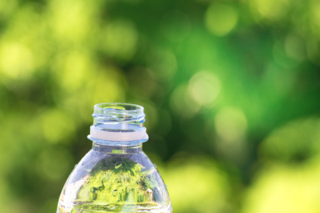 Bottle water made to plastic on sky and tree blurry background.Using wallpaper for package or...