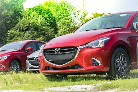 BANGSAN, THAILAND - OCTOBER, 13, 2017 :  This car  mazda 2 brand japan red color parked car stock in showroom of thailand for customers.のeditorial素材
