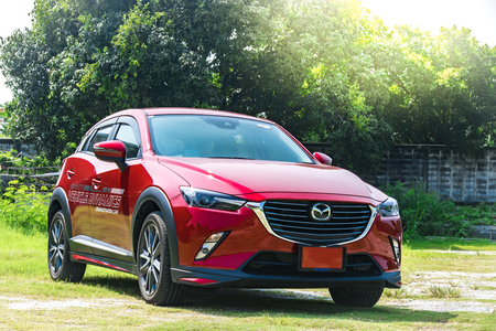 BANGSAN, THAILAND - OCTOBER, 29, 2017 :  Test drive car mazda cx 3 brand japan parked on lawn with tree blurry background in showroom of thailand for customers.のeditorial素材