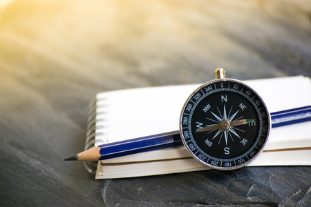 Notepad with compass wood background. Using wallpaper or background travel or navigator image.の写真素材
