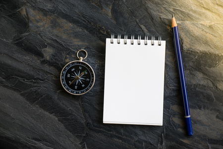 Notepad with compass wood background. Using wallpaper or background travel or navigator image.の写真素材