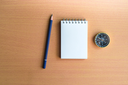 Notepad with compass wood background. Using wallpaper or background travel or navigator image.の写真素材