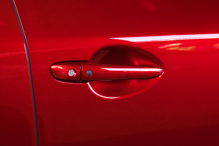 Car door handle red color for customers. Using wallpaper or background for traの写真素材