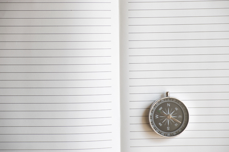 Notepad with compass wood background. Using wallpaper or background travel or navigator image.の写真素材