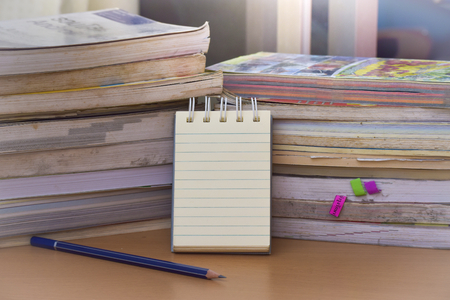 Notepad with pencil on wood board background.using wallpaper for education, business photo.Take note of the product for book with paper and concept, object or copy space.の写真素材
