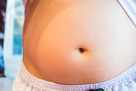 Man belly on blurry background.using Fat, lose weight, Dietary, Diet, slimming imageの写真素材