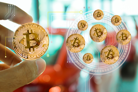 Asian man business holding tecnology bit coin in blurry office background. For business people,...