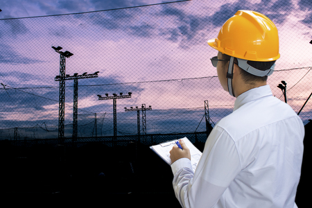 Asian businessman engineer inspection writing in factory With note on notepad or industry blurred background.Metaphor Quality inspection or Production
speed For the best quality to customers.の写真素材