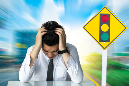 Asian businessman sad sitting or strait Illegal speeding traffic in the 
capital blurred background.Metaphor Traffic to transport management for
automobile or automotive car image.の写真素材