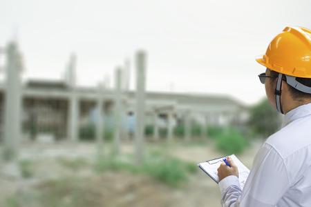Male engineer inspection checking in factory With note on notepad or industry blurred background.Metaphor Quality inspection or Production speed For the best quality to customers.の写真素材