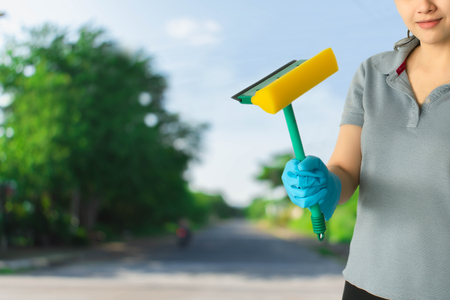 Female cleaning staff in bathroom blurred background Metaphor for cleaning Get rid of germs In bathroom, home office or industry.For reliability And satisfaction of service and customersの写真素材