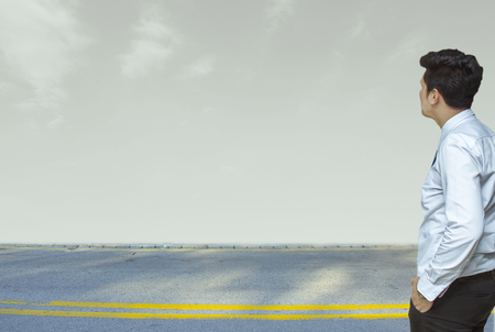 Business man standing on street and room sky blurred background.metaphor to business in development, success, entrepreneur or employment and advertising imageの写真素材