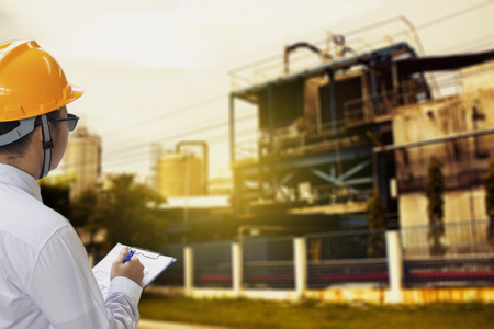 Male engineer inspection checking on industrial background With note 
on notepad or clipboard.Metaphor Quality inspection or Production 
speed For happy new year 2019 imageの写真素材