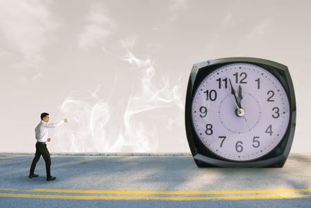 Business men with clock on street and room sky blurred background. Metaphor success freedom imagination concept imageの写真素材