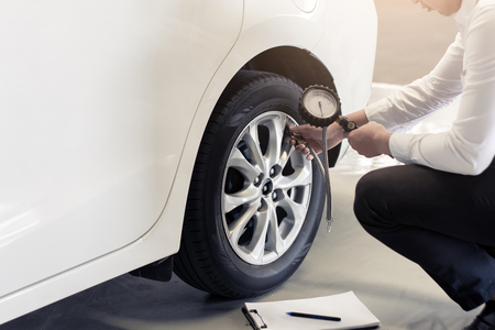 Asian man car inspection Change wheel Rubber tires car.Close up hand holding car screw driver for car tyre car screw driver for automotive, automobile imageの写真素材