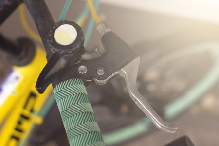 Closeup hand brake mountain bike handle caliper bicycle blurredtree background for Exercise for health imageの写真素材