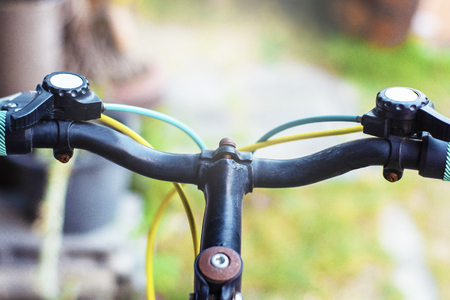 Closeup hand brake mountain bike handle caliper bicycle blurred tree background for Exercise for health imageの写真素材