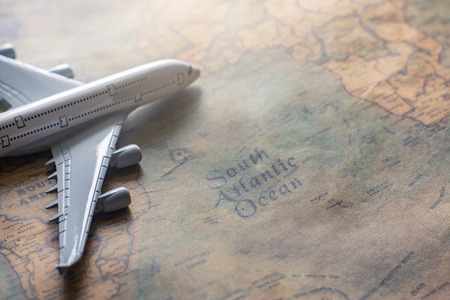 Airplane on paper map for travel adventure discovery image