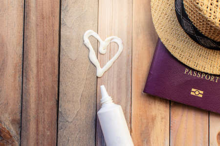 passport with hat and sun block cream for travel adventure discovery image