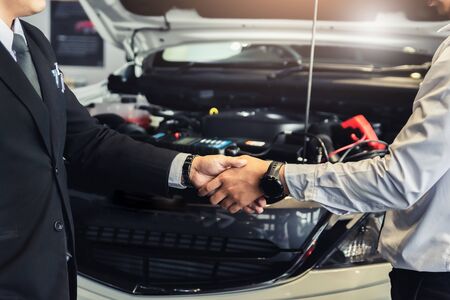 Two men Asian holding hands or shake hands to mechanic with boss manager service inspection. for...