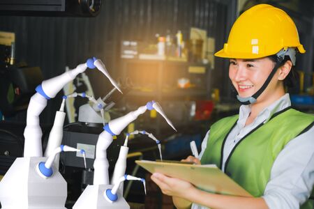 Asian female engineer factory inspection with robot ai machine ssist production engineer in industry...