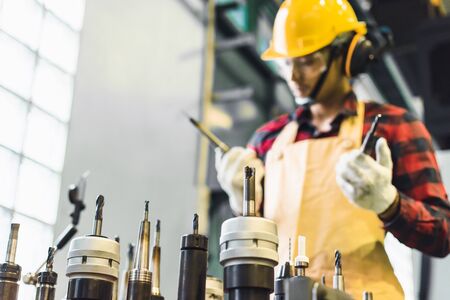Asian man engineer factory inspection with man business engineer hold tool in industry working metalwork control in industrial In a plastic factory for carの写真素材