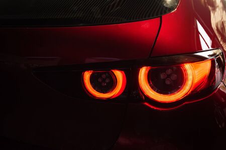 Close up car tail light red color on service blurry background.Using wallpaper background for...