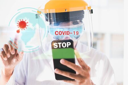Asian man scientist Chemical research working in lab inject with Hold smartphone scanning Covid 19 for stop covid 19 virus covid-19 or corona protected Help protect For world and people stop virusの写真素材