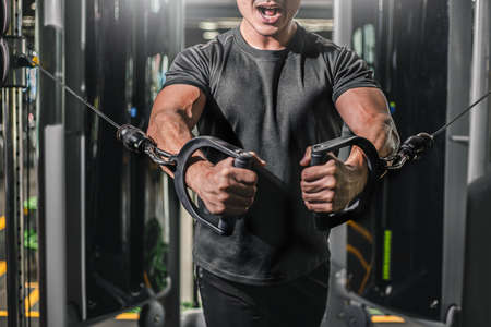 Asian men exercise chest workout on bench press cable machine lifestyle of man for fitness...