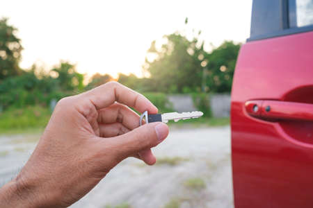 Asian man blurred holding in key car in dealership service maintenance insurance and receives the...