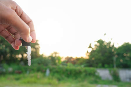Asian man blurred holding in key car in dealership service maintenance insurance and receives the keys from the customer for send happiness car to travelの写真素材