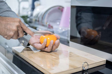 Blurred man asian cooking in kitchen of home He hands cutting vegetables and cutting fruit in the...