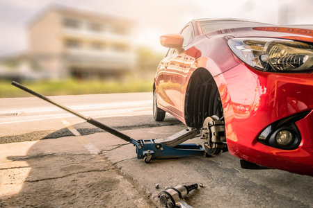 Red car in station repair service car maintenance for industry rubber wheels tire vehicle auto car change garage repairing problem transport automobile service automotive maintenanceの写真素材