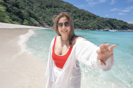 Asian caucasian family taking selfie in  vacation to smiles on the beach so joyful feeling with family of holiday togetherness joy relationship lifestyle asians peopleの写真素材