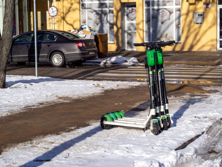 Gdynia Poland-02.05.2021: Electric scooters abandoned in the snow on the busy streets of Gdyniaのeditorial素材