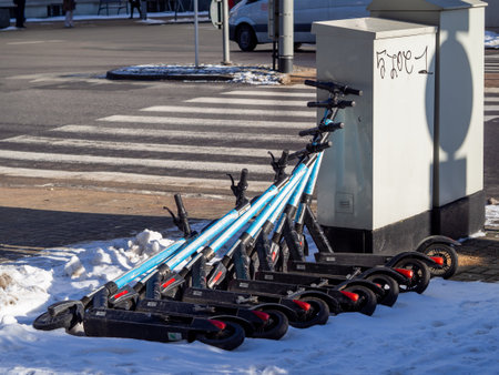 Gdynia Poland-02.05.2021: Electric scooters abandoned in the snow on the busy streets of Gdyniaのeditorial素材