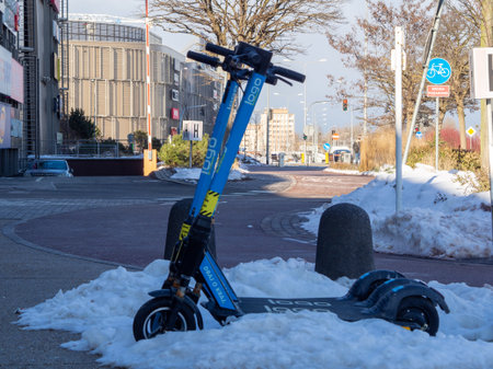 Gdynia Poland-02.05.2021: Electric scooters abandoned in the snow on the busy streets of Gdyniaのeditorial素材