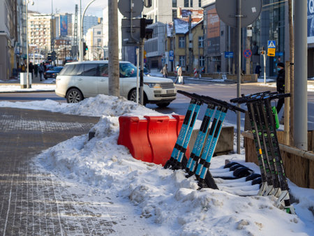 Gdynia Poland-02.05.2021: Electric scooters abandoned in the snow on the busy streets of Gdyniaのeditorial素材
