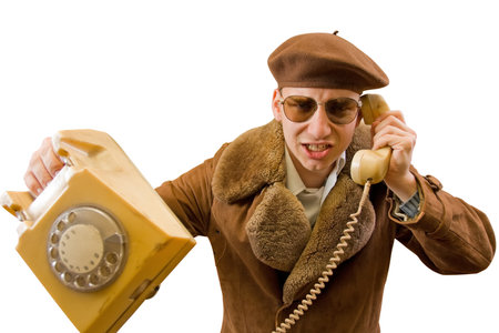 Young angry man talking on the old phone