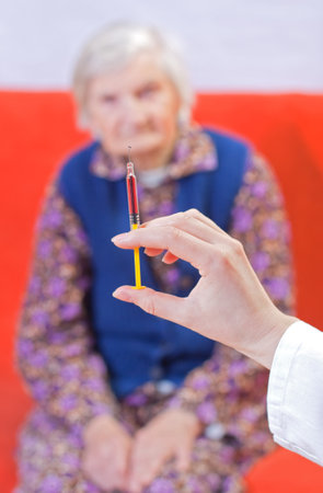 The doctor gives old woman's an injection  の写真素材