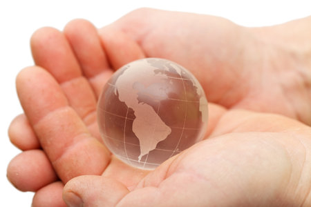 Closeup of a glass globe holding in handsの写真素材