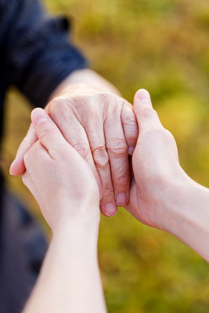 Young doctor hold elderly hands  の写真素材