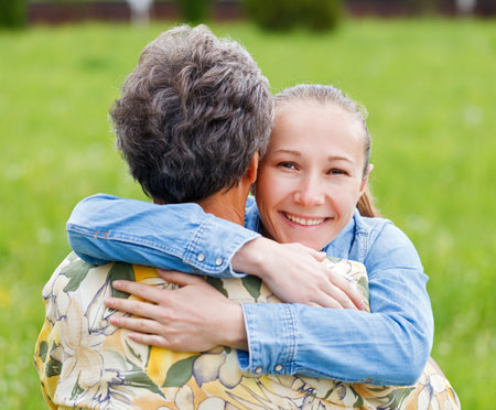 Young girl hug her mother and she enjoyingの写真素材